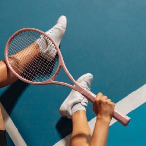 Person holding pink tennis racket