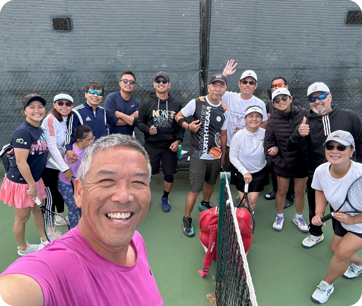 Group of tennis players smiling on court